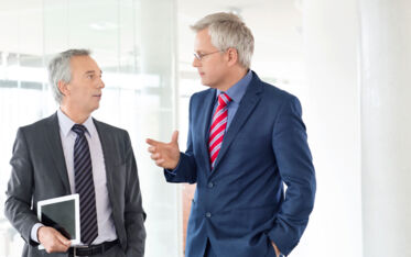 stock-photo-61369856-mature-business-men-discussing-work-in-office